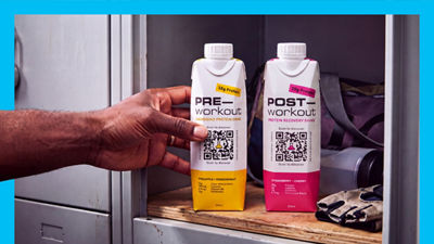 Hand reaching for workout drink in Tetra Prisma Aseptic carton, 2  packages