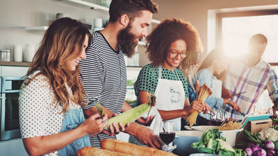 Young people in kitchen cooking together