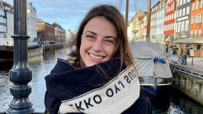 Woman smiling in front of harbour