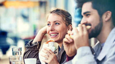A-couple-at-a-cafe-eating-cheese-sandwich