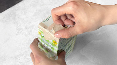 hand touching paper-based cap