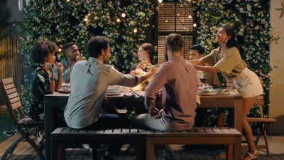 friends having dinner around a table outside