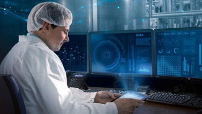 Lab worker in front of computer