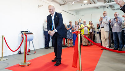Charles Brand cutting a ribbon