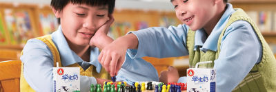 Two asian children playing chess