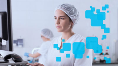 Female opertor monitoring production in computer screen