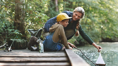 Mother and child at a pond in the woods