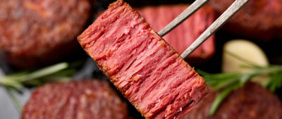 Slices of plant based vegan meat steak on meat fork