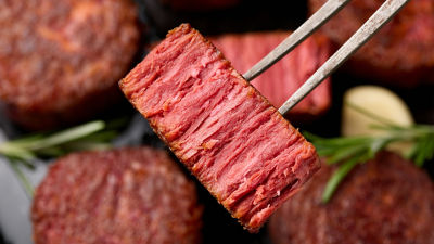 Slices of plant based vegan meat steak on meat fork