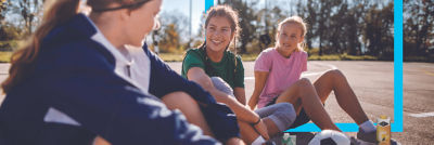 Girls sitting on basket field
