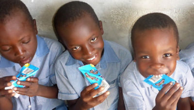 School children in Haiti with Tetra Classic Aseptic carton packages