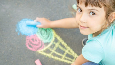 Girl painting ice cream with crayons