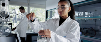 scientist pouring liquid