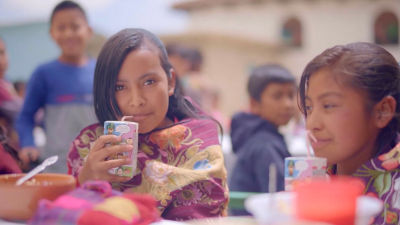 Young girls drinking from cartons
