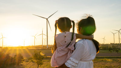 woman holding child and windmills 