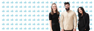 Three diverse people standing together and smiling 