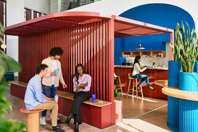 colleagues chatting in an open office vibrant environment