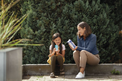 Woman child with carton outside