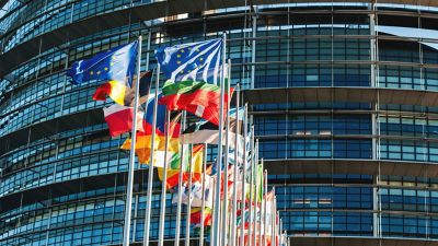 flags in front of the European Parliament
