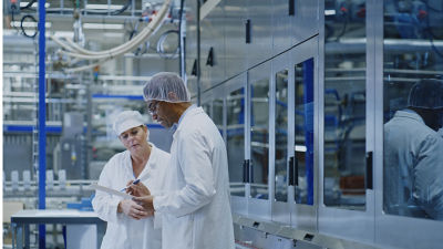 two people in a tetra pak factory