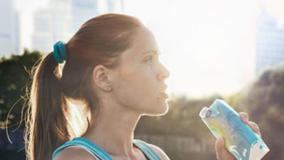 woman drinking yoghurt in the sunshine