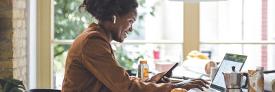 Woman with mobile sitting at desk