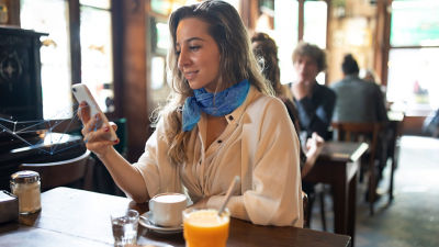 Woman with iphone in coffee shop