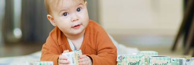 Baby with baby-food in Tetra Recart cartons