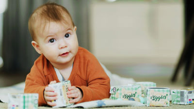Baby playing with Tetra Recart food packages