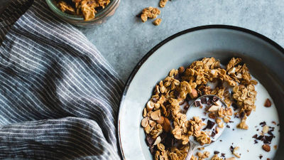 Bowl with granola and milk, napkin on the side