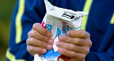 Boy folding carton