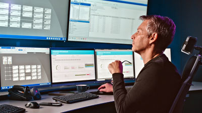 automation operator looking at screens