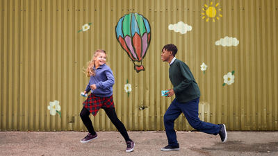 boy and girl running and smiling