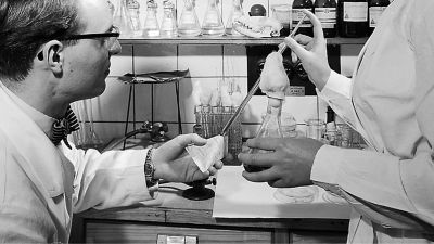 Two workers carton testing in a lab