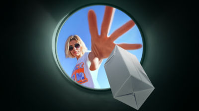 Woman throwing carton in recycling bin