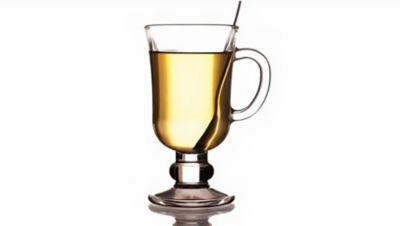 Yellow beverage in glass with white background