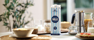 Breakfast table, white milk in Tetra Pak carton package