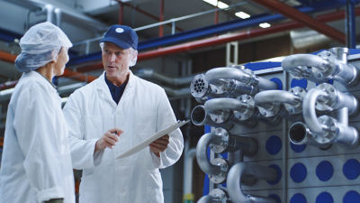man woman talking in factory