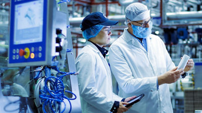 Tetra Pak operator and customer examining carton package