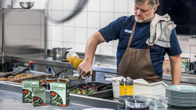 Chef in kitchen using food products in Tetra Recart cartons