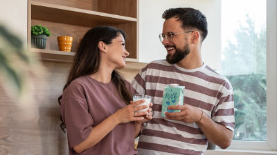 Couple with milk in glass and carton package