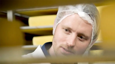 Man looking at cheese