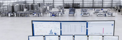 Automation data on screens, production line in background