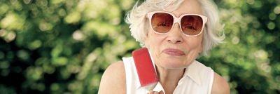 Elderly woman eating ice cream