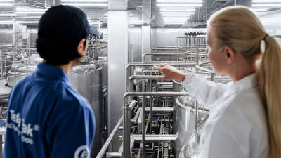 man and woman inside a food and beverage plant