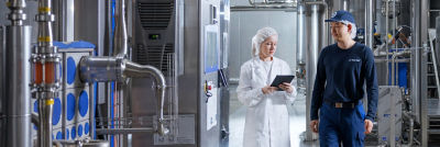 People at production site, processing equipment