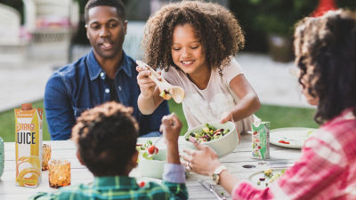 Family eating salad outside