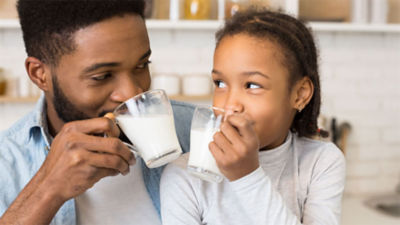 girl drinking milk from carton