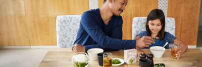 Father and daughter eating soup