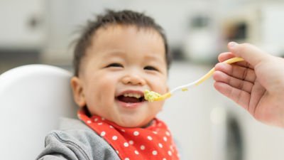Alimentación de un bebé con alimento para bebés
